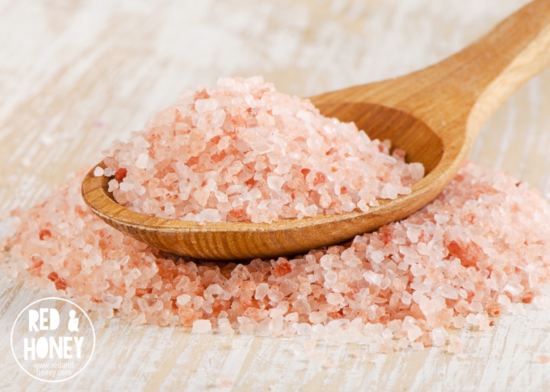 pink salt in a  wooden spoon