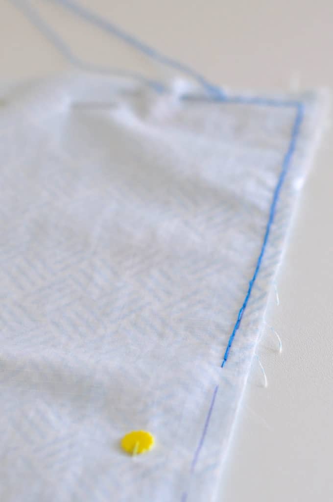 Blue Hand sewn back stitch is shown along the edge of the white nylon.