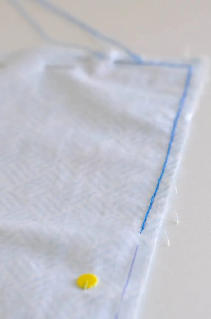 Blue Hand sewn back stitch is shown along the edge of the white nylon.