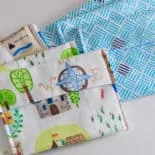 9 DIY snack bags in coordinating prints and colours are laid out on a white surface.