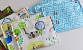 9 DIY snack bags in coordinating prints and colours are laid out on a white surface.