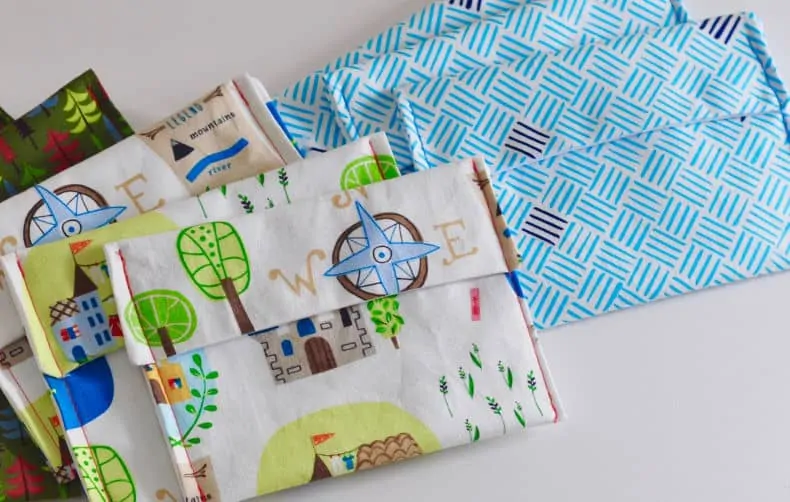 9 DIY snack bags in coordinating prints and colours are laid out on a white surface.
