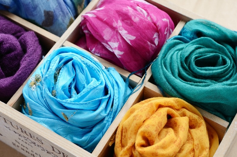 Wooden box with different colorful scarfs