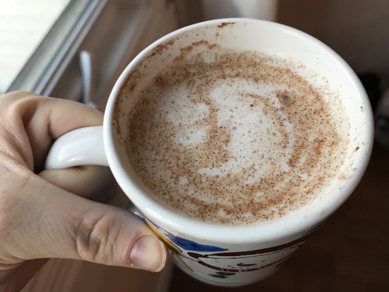A mug of delicious Bulletproof Milk (a Red and Honey Recipe!) with cinnamon sprinkled on top.