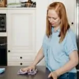 Woman wiping countertop with Norwex cloth