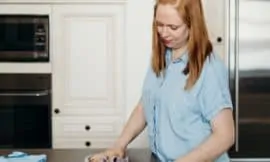 Woman wiping countertop with Norwex cloth