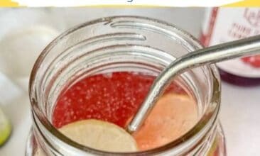 overhead shot of a pink drink in a quart jar with a strainless steel straw, and a slice of lime, with text overlay for pinterest